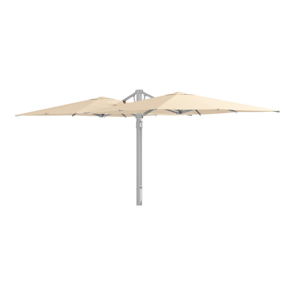 A large sand-colored twin cantilever umbrella with a silver aluminum frame and hydraulic lift.