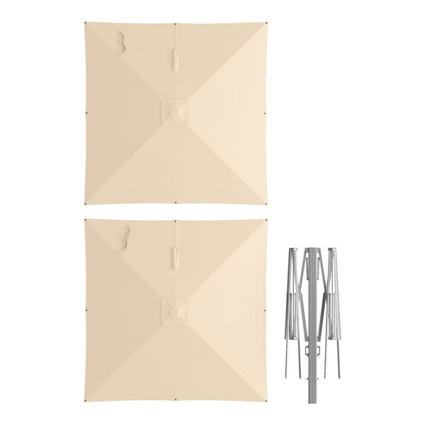 A 10-foot square sand-colored twin cantilever umbrella with a silver aluminum hydraulic lift frame.