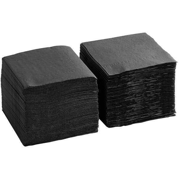 A stack of black, square, 2-ply beverage or cocktail napkins.
