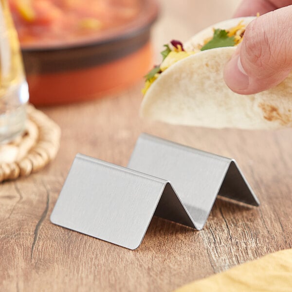 A stainless steel mini taco holder with one or two compartments for holding tacos upright.