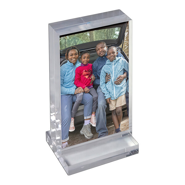 A clear acrylic block frame with a portrait photo displayed on an acrylic base.