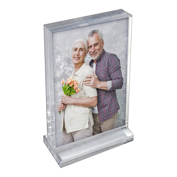 An acrylic block frame on an acrylic base displaying a portrait photo.