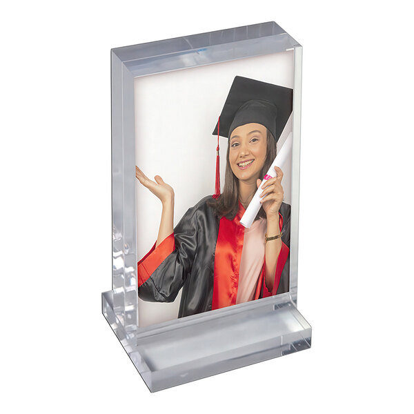 A clear acrylic block frame with a base, displaying a portrait photo of a graduate.