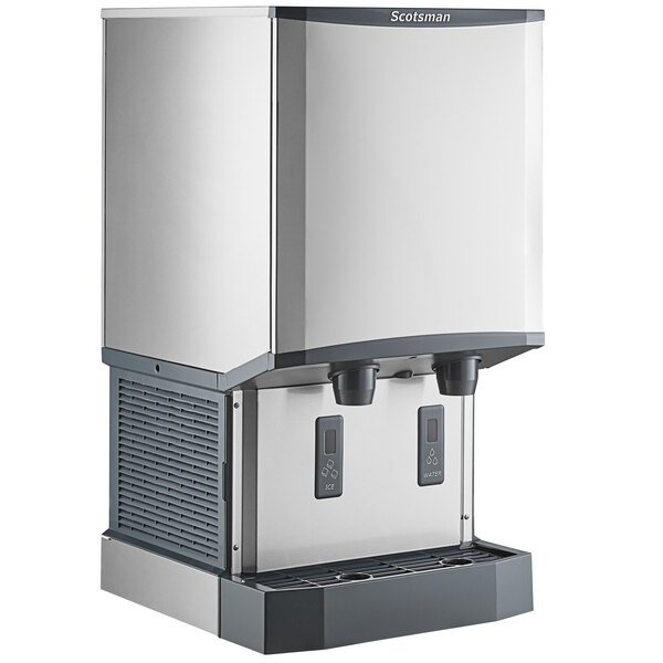 A countertop nugget ice machine and water dispenser with hands-free dispensing and a stainless steel exterior.