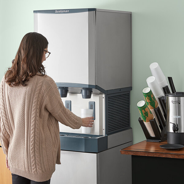 A Scotsman Meridian water-cooled countertop nugget ice machine and water dispenser with hands-free dispensing.