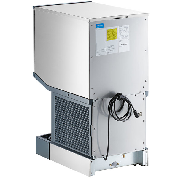 A commercial countertop nugget ice machine and water dispenser with a stainless steel exterior and push button dispensing.