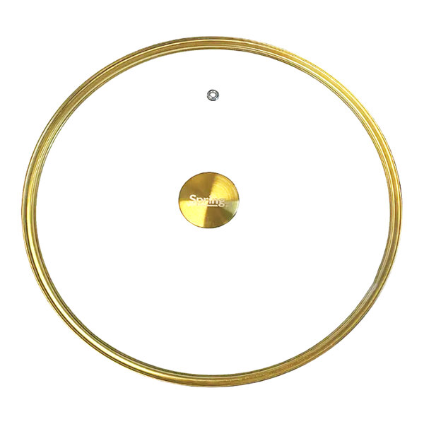 A round tempered glass cover with gold accents and a central gold handle.