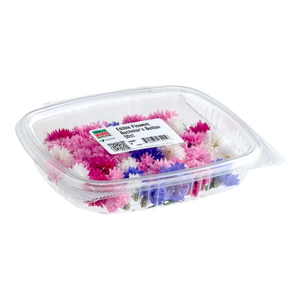 A clear plastic container filled with assorted Fresh Origins Bachelor's Button edible flowers in pink, purple, and white colors.