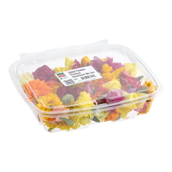A clear plastic container filled with a premium assortment mix of edible flowers.