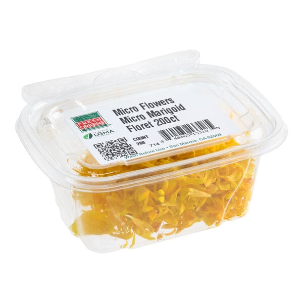 A clear plastic container filled with yellow micro marigold edible flowers.