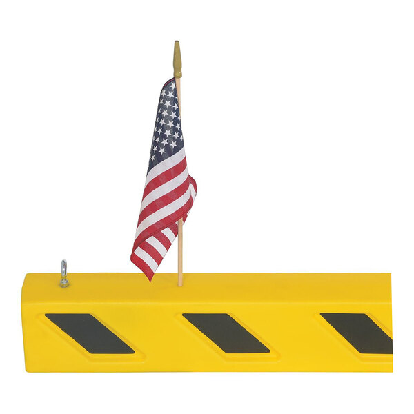 A yellow overhead door guard with black diagonal stripes and an attached American flag.