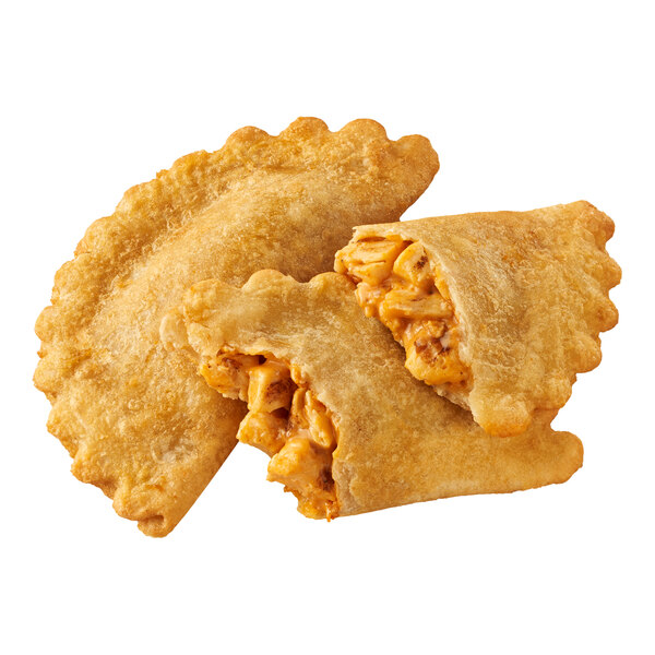 An empanada filled with chicken and cheese, with one whole and one cut open to show the filling.