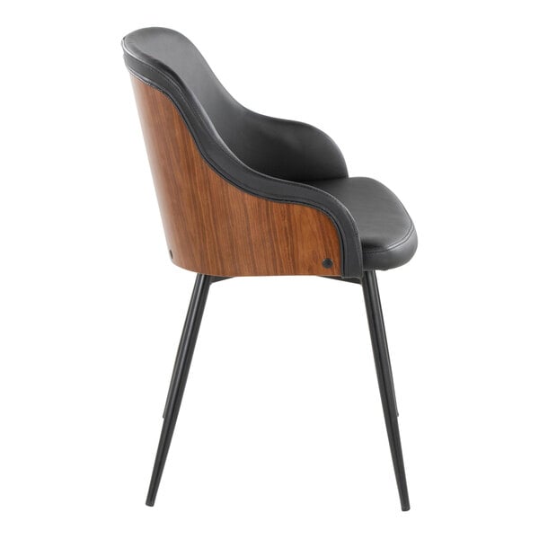 A modern armchair with a walnut wood back, black faux leather upholstery, and black metal legs.