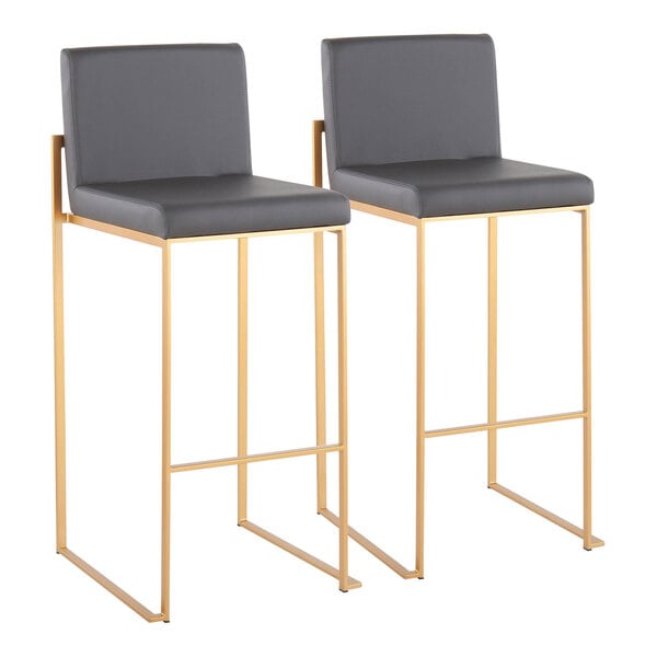 A pair of modern barstools with gray faux leather seats and backs, featuring gold steel frames.