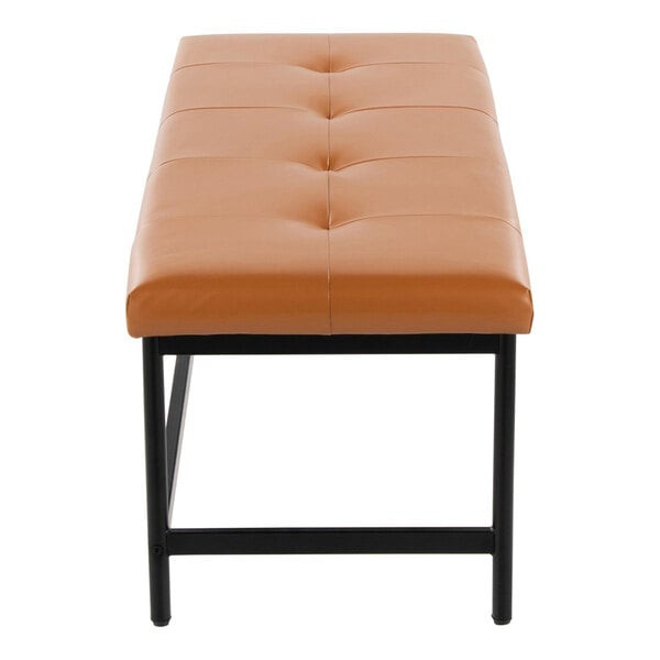 A rectangular bench with camel-colored faux leather upholstery and a black metal frame.