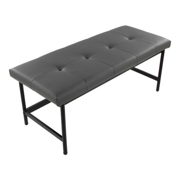 A gray faux leather bench with a tufted seat and a black metal frame.