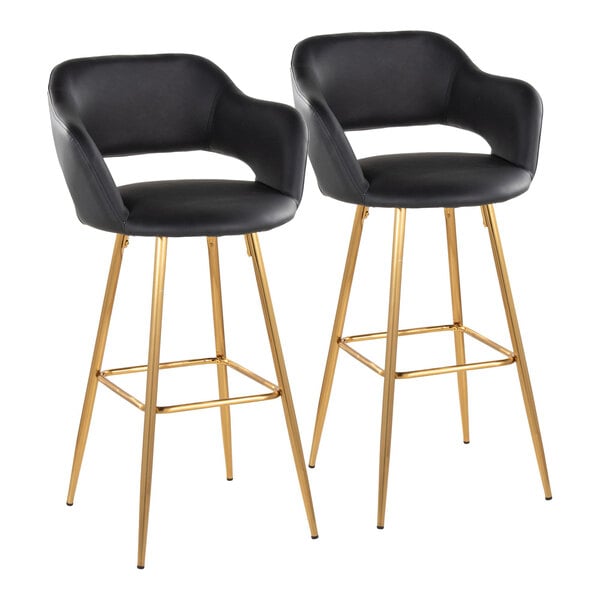 A pair of black faux leather barstools with gold metal legs and armrests.