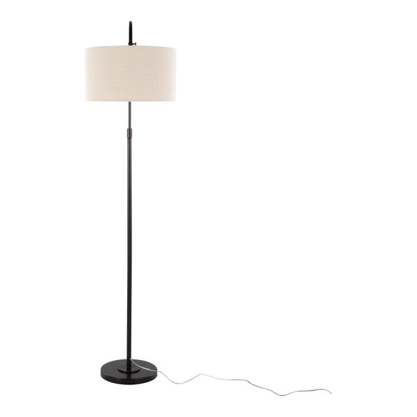 A tall oil bronze metal floor lamp with a natural linen drum shade and a round base.