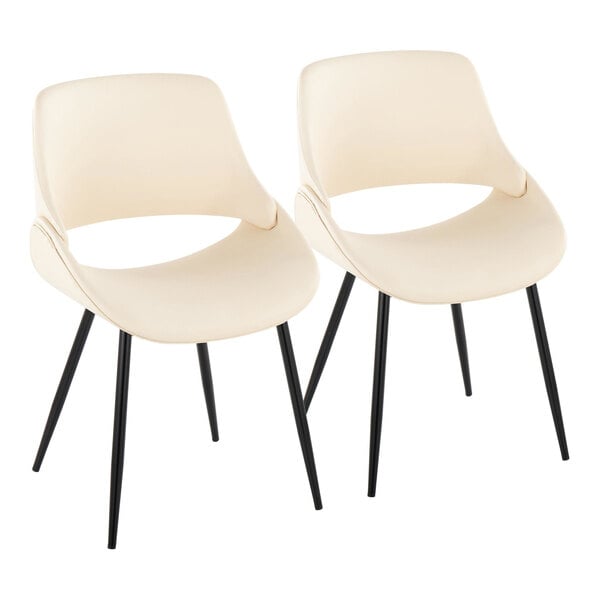A pair of cream faux leather open back chairs with black metal legs.