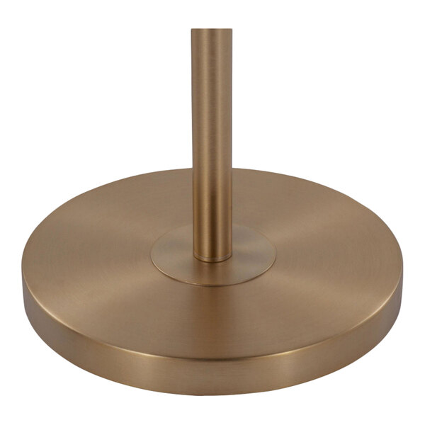 A gold metal base of a floor lamp with a cylindrical pole, part of the LumiSource Casper 69" floor lamp.