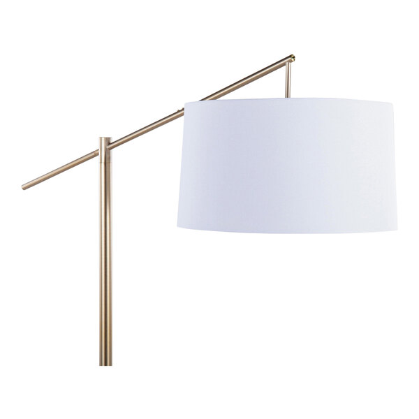 A gold metal floor lamp with an off-white linen drum shade.