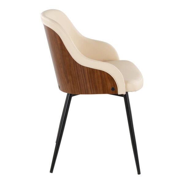 A modern armchair with a walnut wood back, cream faux leather upholstery, and black metal legs.