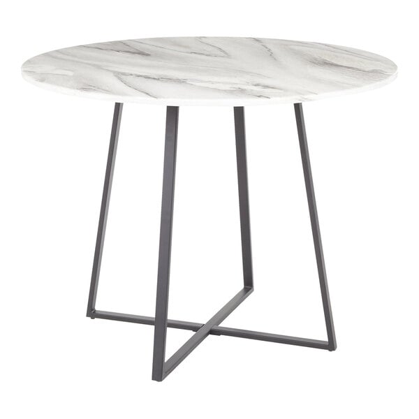 A round dining table with a white marble top and a black metal base.