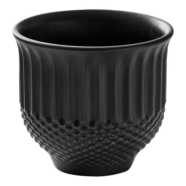 A black round porcelain mug with a textured lower half and a smooth upper half.
