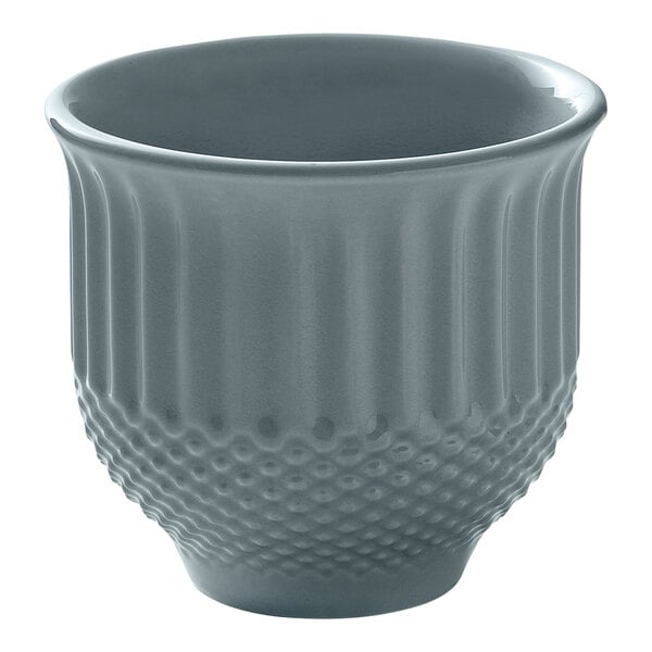 A round, sky blue porcelain mug with a textured lower half and smooth upper half.