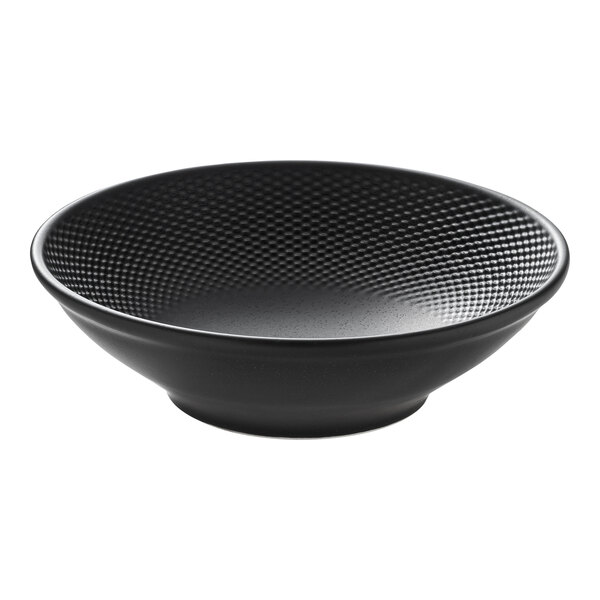 A round black porcelain bowl with a textured interior surface.