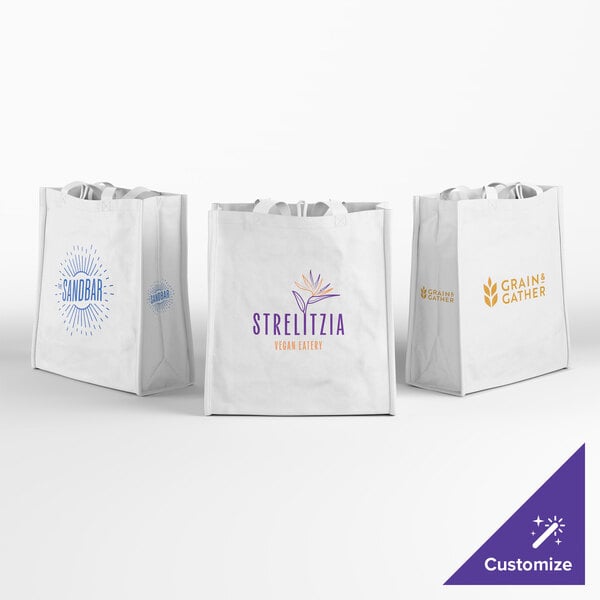 Three white reusable shopping bags with different colorful logos and text printed on the front, displayed against a plain white background.