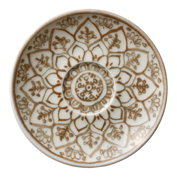 A round porcelain saucer with a sienna-colored floral and geometric pattern.