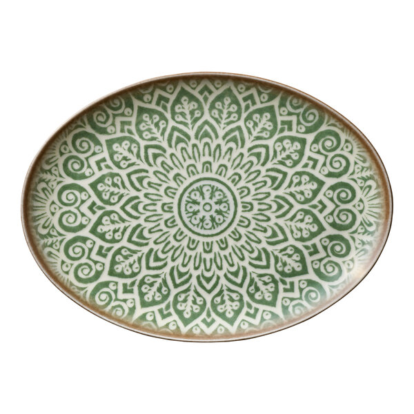 An oval jade porcelain platter with an intricate green and white mandala pattern.