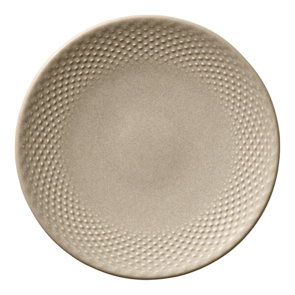A round almond-colored porcelain coupe plate with a textured rim.