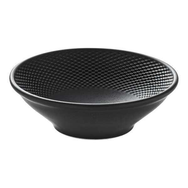 A round black porcelain bowl with a textured interior.