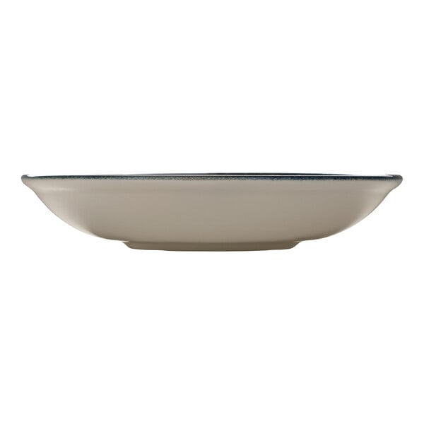 A round white deep porcelain coupe plate with a blue rim.