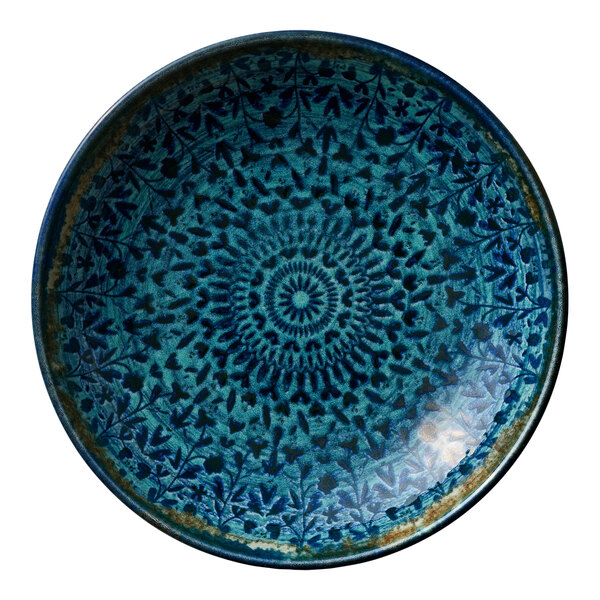 A round deep porcelain coupe plate with a blue patterned design and rim.