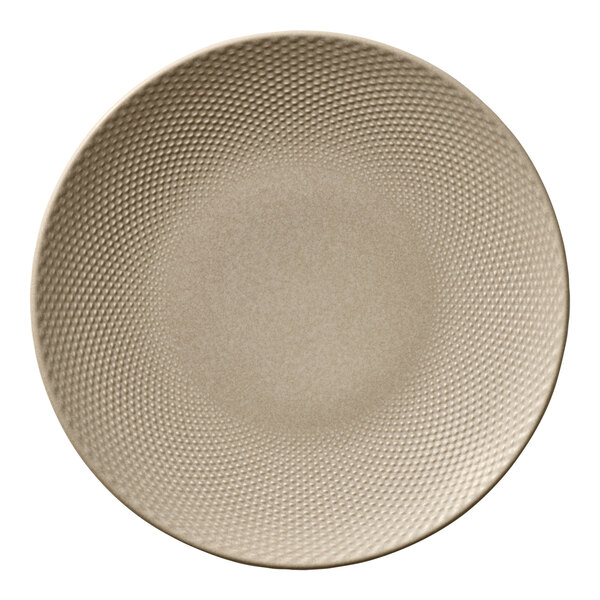 A round almond-colored porcelain coupe plate with a textured pattern.