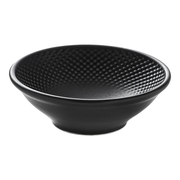 A round black porcelain bowl with a textured interior.