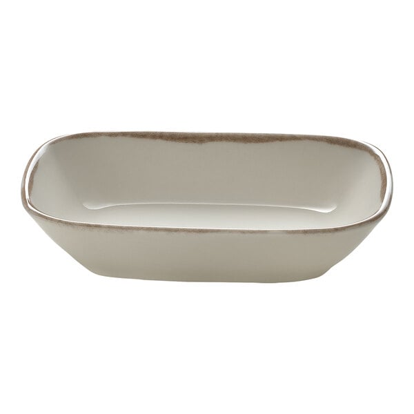 A rectangular white porcelain bowl with a brown rim.