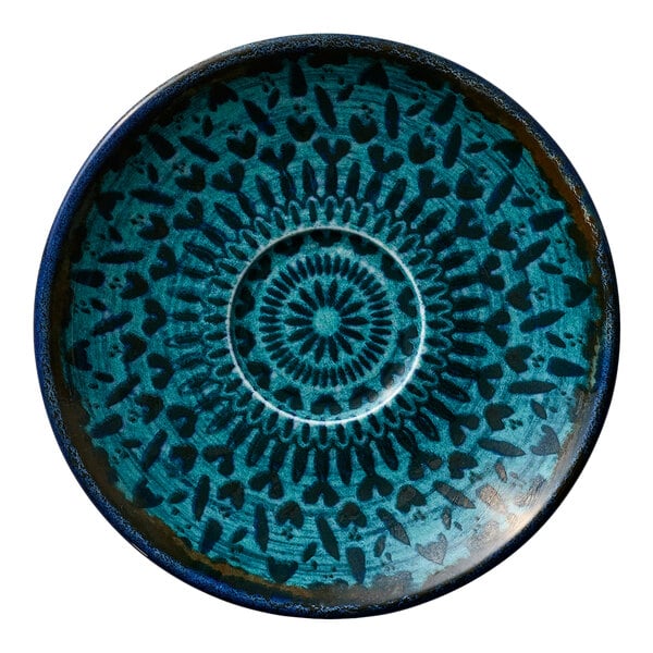 A round blue porcelain saucer with a decorative heart and geometric pattern.