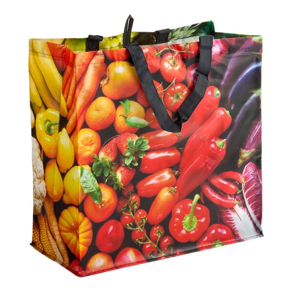 A large reusable shopping bag with black handles and a colorful fruit and vegetable print.