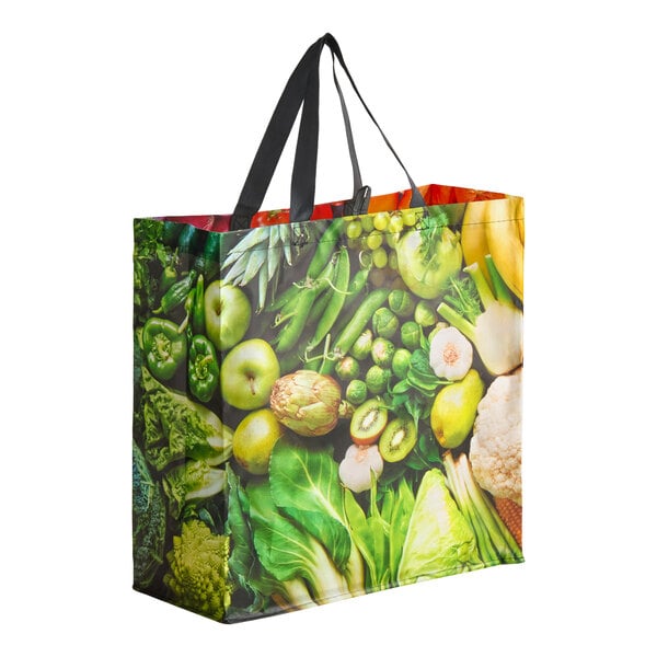 A large reusable shopping bag with a colorful fruit and vegetable print and black handles.