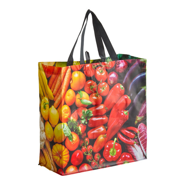 A large reusable shopping bag with black handles and a colorful fruit and vegetable print.