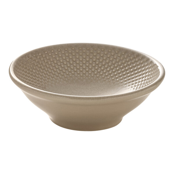 A round almond-colored porcelain bowl with a textured interior.
