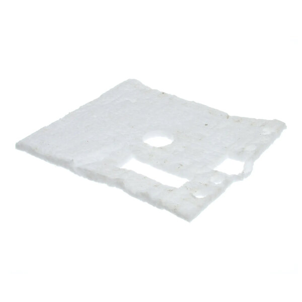 A rectangular piece of white casting insulation with several cutouts and holes.