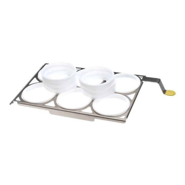 A metal egg rack with six circular slots, each holding a white plastic egg ring.