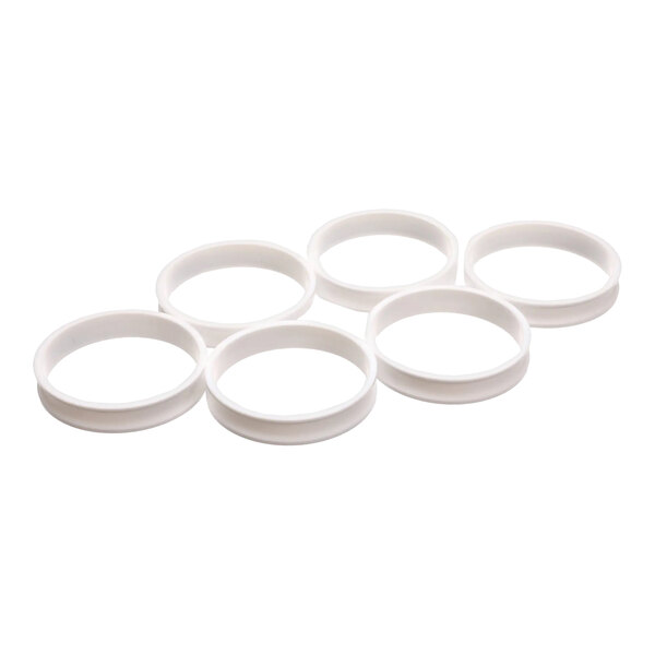 A set of six white plastic egg rings.