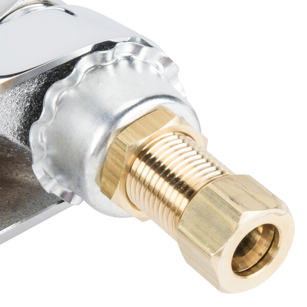 A close up of a T&amp;S brass and gold medical faucet with gooseneck spout and lever handles.