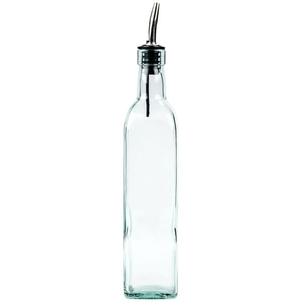 A clear glass olive oil cruet with a metal pourer attachment.